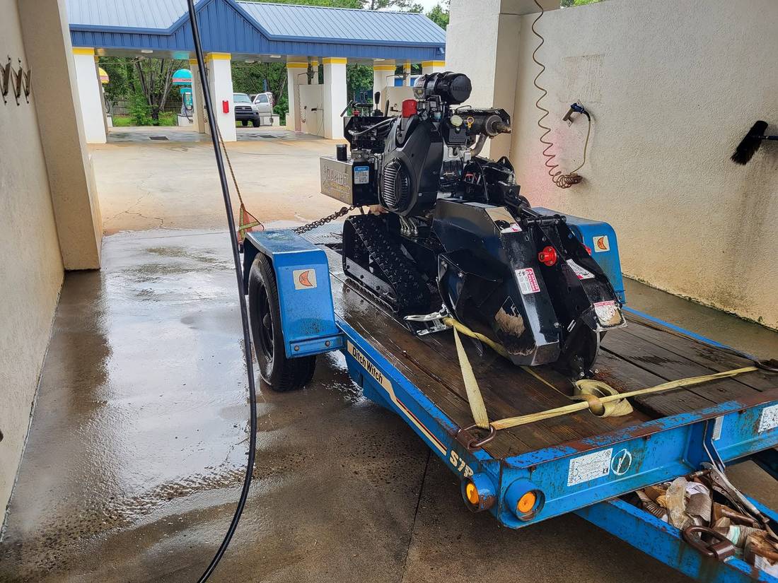 Stump grinder loaded and strapped on a trailer